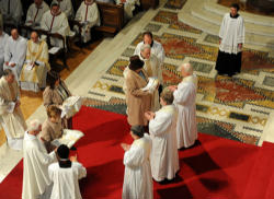 The wives of the first three priests of the Anglican ordinariate in the Catholic Church bring forth their priestly vestments during the Rite of ordination in Westminster Cathedral. The wives of the first three priests of the Anglican ordinariate in the Catholic Church bring forth their priestly vestments during the Rite of ordination in Westminster Cathedral.