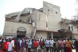 Nigerian catholics outside of St Theresa's catholic Church after the bombing Nigerian catholics outside of St Theresa's catholic Church after the bombing