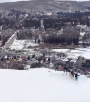 Although the skiers lifted off the ground at different times, all 30 skiers were still holding hands when they touched the ground. Although the skiers lifted off the ground at different times, all 30 skiers were still holding hands when they touched the ground.