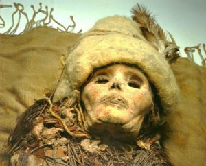 The mummies sport felt caps with feathers, woolen capes and leather boots. They were buried with precious objects including woven baskets, carved masks and a medicinal herb, as well as the cheese. The mummies sport felt caps with feathers, woolen capes and leather boots. They were buried with precious objects including woven baskets, carved masks and a medicinal herb, as well as the cheese.