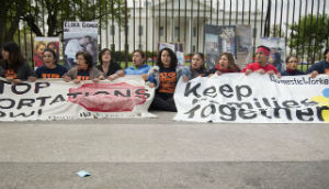 Protestors of U.S. immigration and deportation policy sit with banners outside the White House. Protestors of U.S. immigration and deportation policy sit with banners outside the White House.