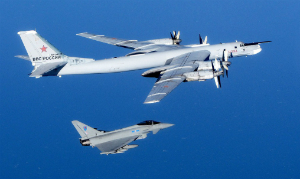 A NATO fighter escorts a Russian long-range bomber. Several such flights have occurred recently as the Russians assert themselves as a superpower once more.