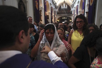 A penitent Christian coming forward to receive ashes at an Ash Wednesday liturgy A penitent Christian coming forward to receive ashes at an Ash Wednesday liturgy