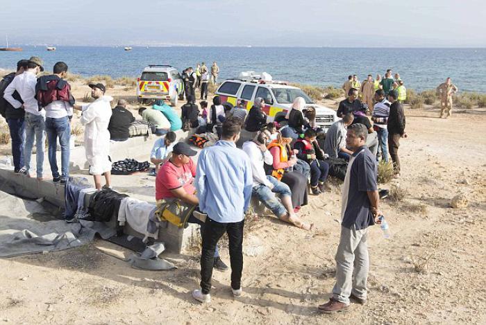 Refugees come ashore just hundreds of yards from the airstrip. Their arrival was undetected until they are well ashore.