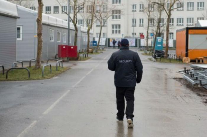 A security guard walks through an emergency shelter for refugees in Germany.