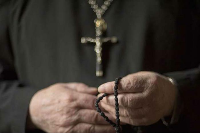 Priest attacked and robbed outside parish.