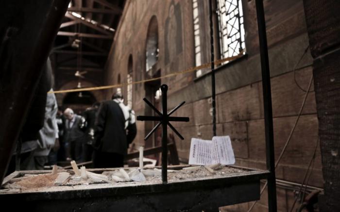 Security forces examine the scene within the damaged cathedral.