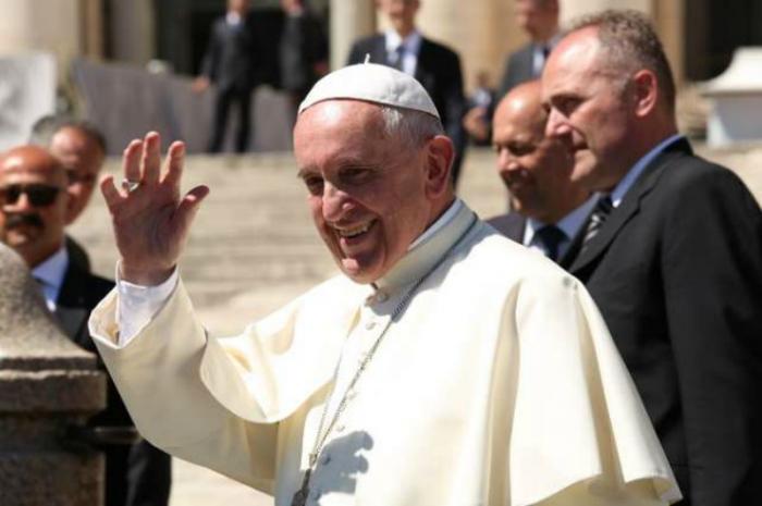 Pope Francis waves to pilgrims in St. Peter