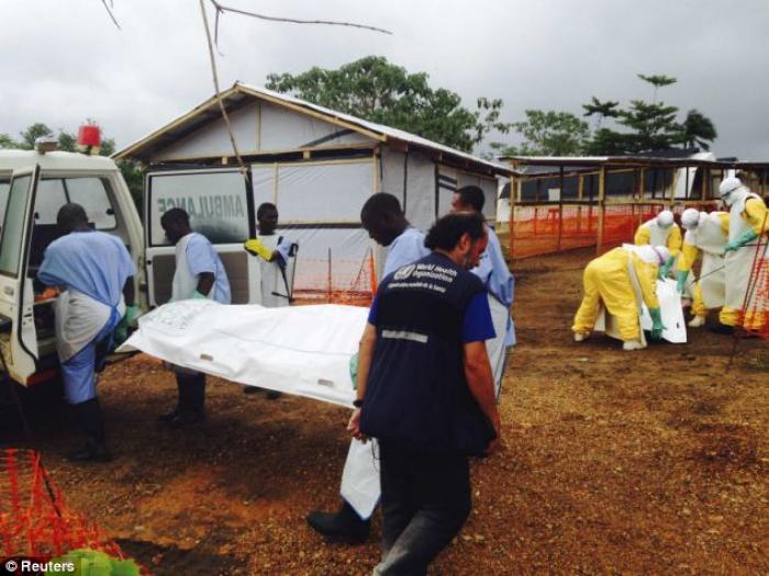 Volunteers carry bodies to a van in a medical center for Ebola patients in Kailahun, Sierra Leone. Volunteers carry bodies to a van in a medical center for Ebola patients in Kailahun, Sierra Leone.