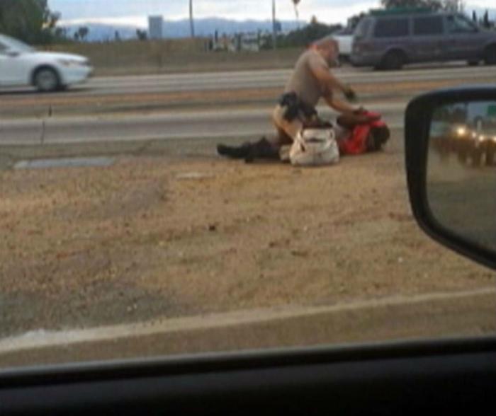 This grainy picture is taken from a video showing a California Highway Patrol officer beat a woman o This grainy picture is taken from a video showing a California Highway Patrol officer beat a woman o