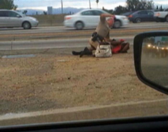 This grainy picture is taken from a video showing a California Highway Patrol officer beat a woman o This grainy picture is taken from a video showing a California Highway Patrol officer beat a woman o