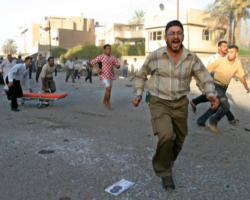 Iraqis run through the streets of Baghdad after bombs exploded in five Catholic churches Aug. 1. The Islamic-Catholic Liaison Committee condemned terrorist violence. At least 11 people died and more than 50 were injured when terrorists made coordinated attacks in Baghdad and Mosul. (CNS photo from Reuters) Image of Iraqis run through the streets of Baghdad after bombs exploded in five Catholic churches Aug. 1. The Islamic-Catholic Liaison Committee condemned terrorist violence. At least 11 people died and more than 50 were injured when terrorists made coordinated attacks in Baghdad and Mosul. (CNS photo from Reuters)