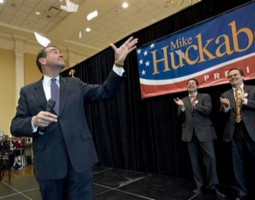 Republican presidential hopeful, former Arkansas Gov. Mike Huckabee, tears up an IRS tax form while addressing students and supporters at the University of Maryland in College Park, Md., Saturday, Feb. 9, 2008. Behind Huckabee are, left to right, Maryland State Delegate Christopher Shanke, and Maryland State Delegate Tony McConkey. Image of Republican presidential hopeful, former Arkansas Gov. Mike Huckabee, tears up an IRS tax form while addressing students and supporters at the University of Maryland in College Park, Md., Saturday, Feb. 9, 2008. Behind Huckabee are, left to right, Maryland State Delegate Christopher Shanke, and Maryland State Delegate Tony McConkey.