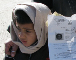 A young Iraqi boy, his mother holding in her hand the official documentation granting him refugee status.The process is painstakingly long and arduous.With more than 4 million people displaced, Iraqis are the third largest and the fastest-growing refugee population in the world. Although the U.S. promised to receive 7,000 Iraqi refugees by October 2007, only 1608 were resettled in the U.S. Image of A young Iraqi boy, his mother holding in her hand the official documentation granting him refugee status.The process is painstakingly long and arduous.With more than 4 million people displaced, Iraqis are the third largest and the fastest-growing refugee population in the world. Although the U.S. promised to receive 7,000 Iraqi refugees by October 2007, only 1608 were resettled in the U.S.