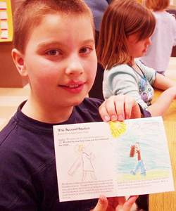 THE STATIONS, ILLUSTRATED - Second grader Zach Olds displays one of the pages in his booklet. (Catholic Herald/Mary Grieco) THE STATIONS, ILLUSTRATED - Second grader Zach Olds displays one of the pages in his booklet. (Catholic Herald/Mary Grieco)