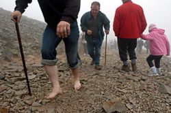 CLIMBING CROAGH - A man made a barefoot ascent of Croagh Patrick to mark St. Patrick's 5th-century fast on the mountain's summit. (Haydn West) CLIMBING CROAGH - A man made a barefoot ascent of Croagh Patrick to mark St. Patrick's 5th-century fast on the mountain's summit. (Haydn West)