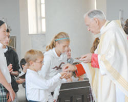 Bishop Hermann gives the Most Blessed Sacrament to children.he is a beloved Bishop and a faithful priest. He is also a courageous champion for life. Image of Bishop Hermann gives the Most Blessed Sacrament to children.he is a beloved Bishop and a faithful priest. He is also a courageous champion for life.