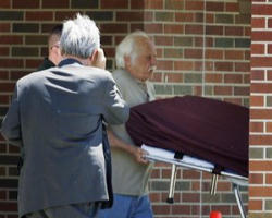 Goerge Tiller being carried away after being shot to death. Image of Goerge Tiller being carried away after being shot to death.