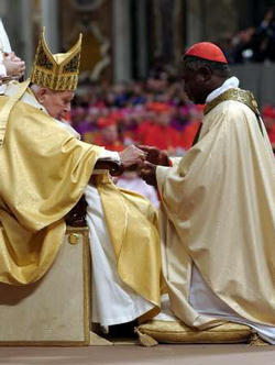 Cardinal Peter Kodwo Appiah Turkson, the archbishop of Cape Coast, Ghana. Newly elevated Cardinal Turkson receives his cardinal ring from Pope John Paul II during a special mass in Saint Peter's Basilica at the Vatican October 22, 2003. Image of Cardinal Peter Kodwo Appiah Turkson, the archbishop of Cape Coast, Ghana. Newly elevated Cardinal Turkson receives his cardinal ring from Pope John Paul II during a special mass in Saint Peter's Basilica at the Vatican October 22, 2003.