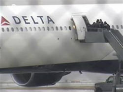 Passengers exiting Delta Flight #253 after an emergency landing. Image of Passengers exiting Delta Flight #253 after an emergency landing.