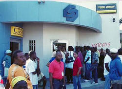 Customers line up outside a Port-au-Prince bank to withdraw money, 24 Jan 2010. Image of Customers line up outside a Port-au-Prince bank to withdraw money, 24 Jan 2010.