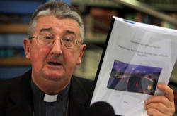 Irish Bishop holding the Murphy Report at a Press Conference Image of Irish Bishop holding the Murphy Report at a Press Conference