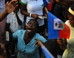 A woman takes part in an open air mass in Port-au-Prince on January 24, 2010. More than 110,000 people have been confirmed as killed in Haiti's devastating earthquake, the Interior Ministry said, making it the deadliest on record in the Americas. Image of A woman takes part in an open air mass in Port-au-Prince on January 24, 2010. More than 110,000 people have been confirmed as killed in Haiti's devastating earthquake, the Interior Ministry said, making it the deadliest on record in the Americas.