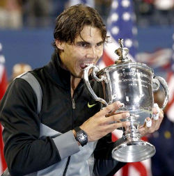 Spanish tennis champ Rafael Nadal always pleases sports photographers with his trademark 'biting' of the trophy. Spanish tennis champ Rafael Nadal always pleases sports photographers with his trademark 'biting' of the trophy.