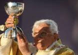 Pope Benedict XVI elevates the sacred Body and Blood of Christ under the sacramental sign of wine in Bellahouston Park, Glasgow. Image of Pope Benedict XVI elevates the sacred Body and Blood of Christ under the sacramental sign of wine in Bellahouston Park, Glasgow.