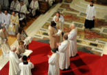 The wives of the first three priests of the Anglican ordinariate in the Catholic Church bring forth their priestly vestments during the Rite of ordination in Westminster Cathedral. Image of The wives of the first three priests of the Anglican ordinariate in the Catholic Church bring forth their priestly vestments during the Rite of ordination in Westminster Cathedral.