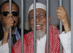 The now-convicted terrorist Abu Bakar Bashir behind bars. Image of The now-convicted terrorist Abu Bakar Bashir behind bars.