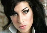 Her black beehive hairdo, cat's eye makeup and old-fashioned sailor tattoos made Amy Winehouse a highly recognizable face on the contemporary music scene. Image of Her black beehive hairdo, cat's eye makeup and old-fashioned sailor tattoos made Amy Winehouse a highly recognizable face on the contemporary music scene.