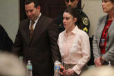 Casey Anthony accompanied by counsel leaving the courtroom after the verdict was read Image of Casey Anthony accompanied by counsel leaving the courtroom after the verdict was read