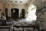 Iraqis survey bomb damage done in today's attacks. Image of Iraqis survey bomb damage done in today's attacks.