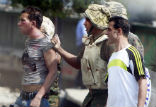 An Egyptian soldier arrests two protesters on Friday. Image of An Egyptian soldier arrests two protesters on Friday.