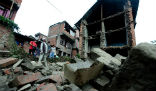 Quake survivors survey damage. Image of Quake survivors survey damage.