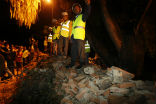 Nepalese rescue workers at the site of the collapse at the British Embassy in Nepal where thee people were killed. Image of Nepalese rescue workers at the site of the collapse at the British Embassy in Nepal where thee people were killed.