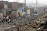 Residents survey the rubble following Friday's quake. Image of Residents survey the rubble following Friday's quake.
