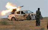 NTC fighters fire a rocket at Qaddafi loyalists in Sirte. Image of NTC fighters fire a rocket at Qaddafi loyalists in Sirte.