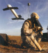 A soldier test launches a Switchblade drone. Image of A soldier test launches a Switchblade drone.