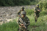 Colombian soldiers on patrol. Chilling reports allege that some of their comrades have been committing gross, systematic atrocities for personal gain. Image of Colombian soldiers on patrol. Chilling reports allege that some of their comrades have been committing gross, systematic atrocities for personal gain.