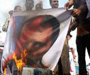 Protesters burn an image of Syrian President Bashar Al-Assad as the rebellion spreads. Image of Protesters burn an image of Syrian President Bashar Al-Assad as the rebellion spreads.