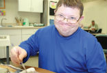 Craig, a happy resident of the DPD works on a craft project. Image of Craig, a happy resident of the DPD works on a craft project.