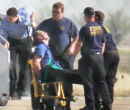 Captain Osborn deplanes strapped to a chair. Image of Captain Osborn deplanes strapped to a chair.