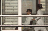 Chen being wheeled by a window in a hospital where he is being held against his will Image of Chen being wheeled by a window in a hospital where he is being held against his will
