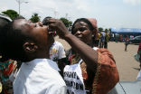 Image of Polio vaccine is easy to administer. In this file photo, an aid worker in the DRC immunizes a young man. 