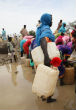 Refugees struggle to obtain what little water they can as supplies run out. Image of Refugees struggle to obtain what little water they can as supplies run out.