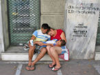 Without food or medicine a Greek family sits outside a local hospital in despair. Image of Without food or medicine a Greek family sits outside a local hospital in despair.