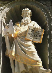 A Baroque facade was added to the lower west front, which centers on a sculpture of St. Matthias holding an axe. The figure holds an open book with a reference to John 15:14: 'You are my friends if you do what I command.' A Baroque facade was added to the lower west front, which centers on a sculpture of St. Matthias holding an axe. The figure holds an open book with a reference to John 15:14: 'You are my friends if you do what I command.'