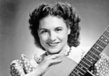 Kitty Wells was an innovator, bringing a female perspective to the male-dominated country music scene. Image of Kitty Wells was an innovator, bringing a female perspective to the male-dominated country music scene.
